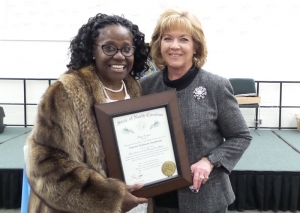 Vancine Sturdivant (left) accepts The Order of the Long Leaf Pine Award from Vickie Daniel.