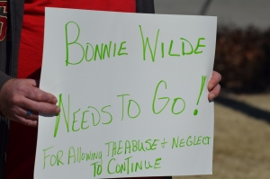 A sign at a Tuesday afternoon protest calls for the termination of Bonnie Wilde, director of the Richmond County Animal Shelter. See more photos in a gallery below.