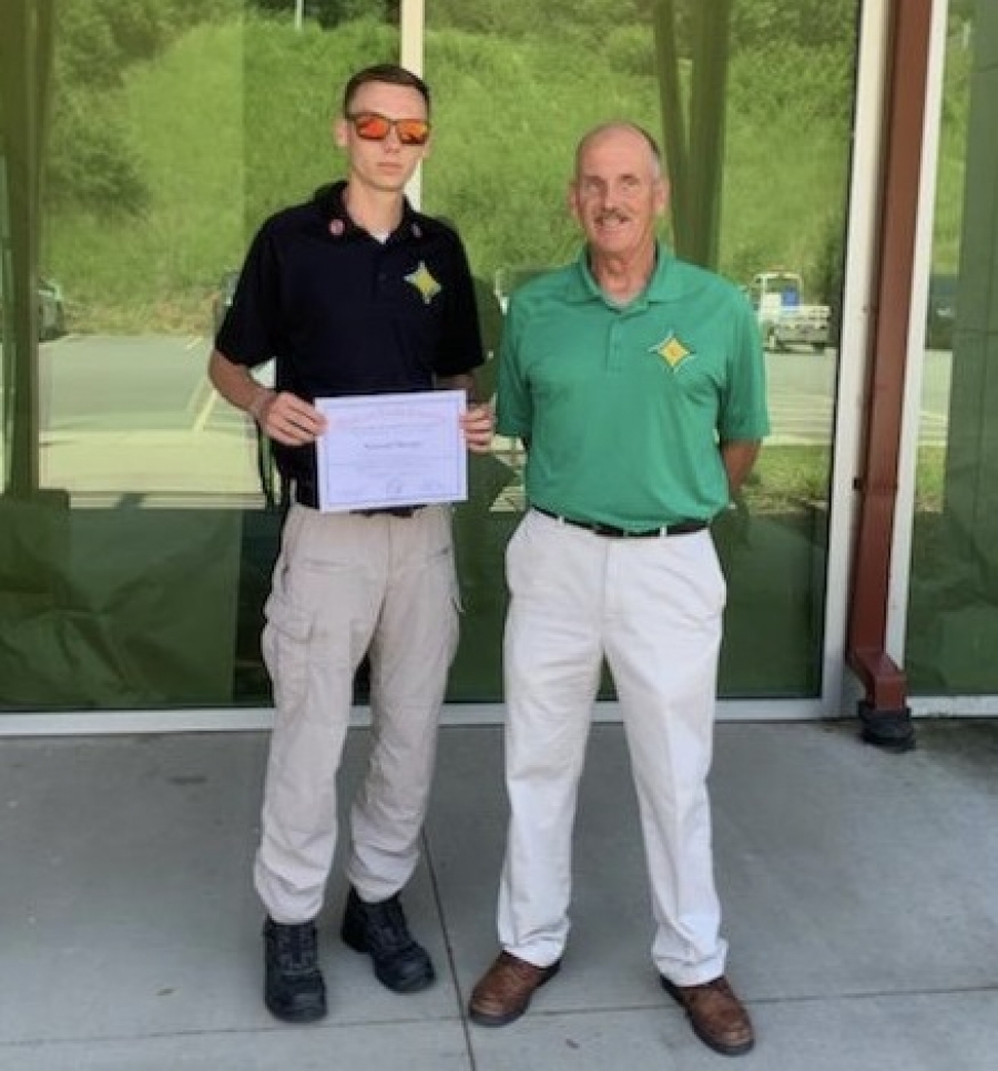 Rising senior Zac Sharpe completed the Office of State Fire Marshall High School Firefighter challenge at the Buncombe County Training Center in Asheville in June. Fire and Emergency Medical Technician Teacher Chief Victor McCaskill, as well as his parents, attended the graduation ceremony. 