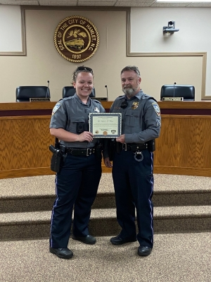 Hamlet Police Officer Stephanie Watson stands in City Hall with Detective Sean Sullivan after she was awarded a meritorious commendation for excellence in service for her role in identifying robbery suspects during a traffic stop.