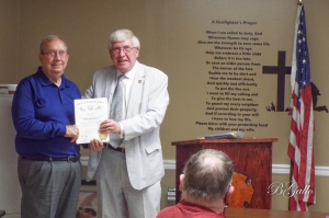 Bill Dennis, left, first chief of the East Rockingham Fire Department, is presented the Order of Long Leaf Pine by state Sen. Tom McInnis on Saturday.