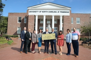 Members of the Julian T. Pierce Memorial Scholarship Committee make a $24,000 contribution to UNCP. 