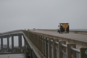 N.C. Department of Transportation crews have been out treating roads across central and eastern North Carolina in advance of the next round of winter weather. In this photo, a NCDOT tandem truck applies salt to the Surf City high-rise bridge on Friday.