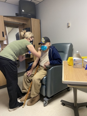 Kim Bowden, R.N., of the Richmond County Health Department, administers the vaccine to 90- year-old Ellerbe resident Bernie Fulp.