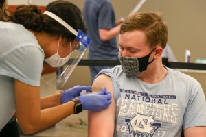 A UNC student receives a COVID vaccination.