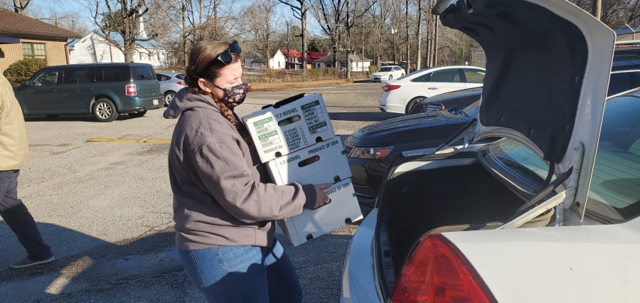 Kim Hotter, meal site manager for the East Rockingham Senior Center, loads three boxes of produce from the Sandhills AgInnovation Center to be delivered to local seniors.