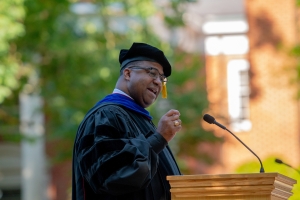 Dr. Russell Booker, a 1991 alum of Wingate, speaks to students at the college&#039;s graduate commencement ceremony May 18.