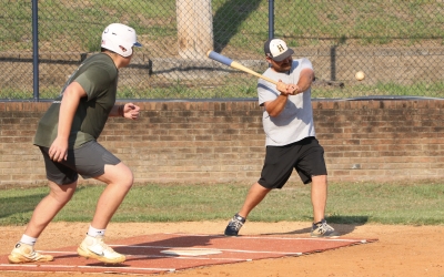 Hamlet Post 49 head coach Chip Gordon hits a ground ball while Jake Clemmons runs to first during Thursday&#039;s practice.