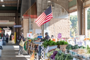 An American flag is flown over a produce stand at the state farmers market in Raleigh.