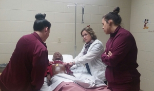 Nursing instructor Ronnie Tunstall works with two students on a mannequin in the RCC Pediatric Lab.