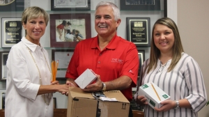 RCS Superintendent Dr. Cindy Goodman graciously accepts a 100-box donation of pencils from Steven Gilmer and Toni Hodges of Church of God of Prophecy.