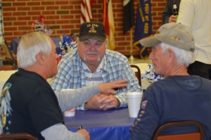 Fred McNeill, center, listens as Eddie Dean, left, recalls memories from serving in the National Guard. McNeill, Dean and Johnny Patrick, right, were the only three to serve in all three units.