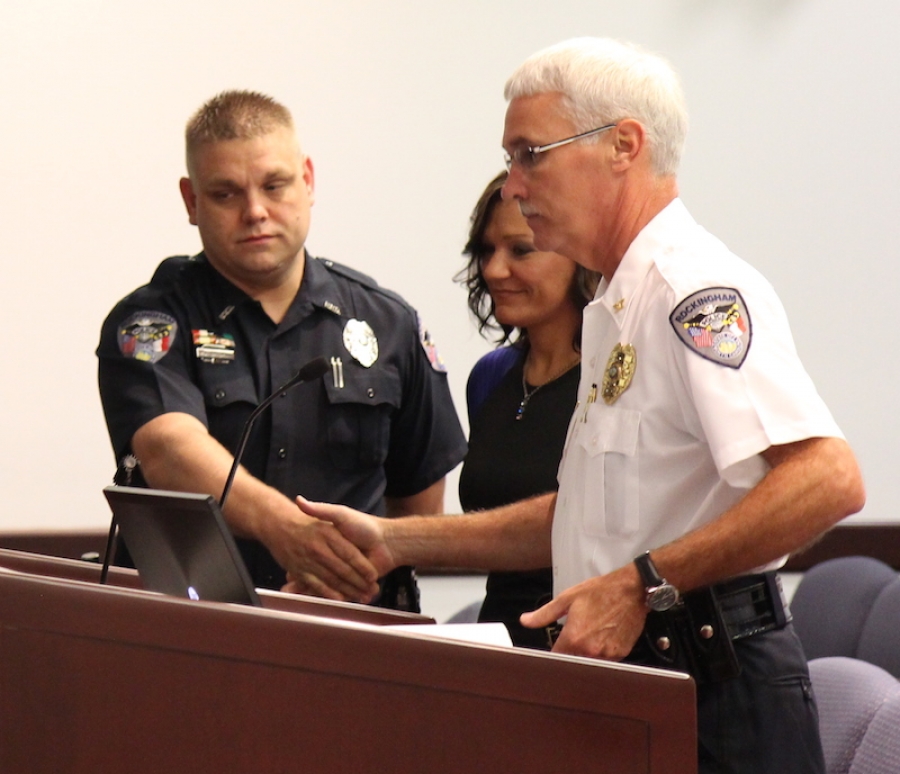Rockingham Police Chief Billy Kelly (right) shakes the hand of Detective Ronald Brigman (left) during his recognition by City Council Tuesday.