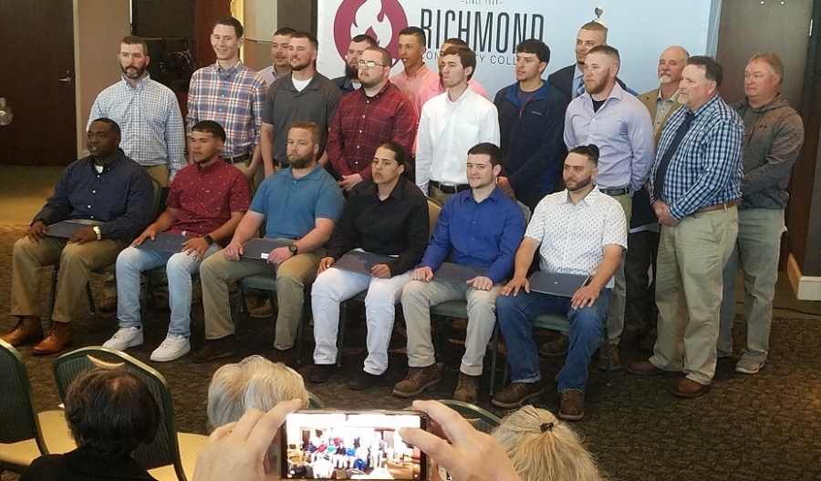Students and instructors from Richmond Community College&#039;s new lineman program pose for a group photo following the graduation ceremony Friday.