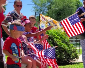 Levi Merrell and Londyn Bright hold small U.S. flags during a Flag Day event Friday at VFW Post 4203 and Veterans Memorial Park.