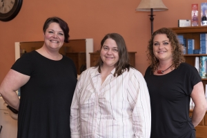 Marcie Cranford (far left) and Stacie Shelvey (far right), sisters from Cheveux, a salon in downtown Southern Pines, offered services in a day of pampering for ladies who are going through cancer treatments.  The program, Look Good…Feel Better, is offered at the Clara McLean House.  Amanda Garner (center) said the ladies made her feel like a princess for a day.   