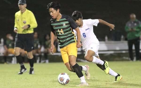 Senior Pedro Molina (14), who scored two goals on Senior Night, moves past Hector Hernandez in the second half.
