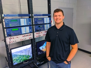 Richmond Senior High School senior Thomas Barbee stands by a bank of relays in the Forte Annex Building at Richmond Community College. Barbee has been dually enrolled in college classes for the Electric Utility Substation &amp; Relay Technology program at RichmondCC, and he will be working as an intern this summer at Duke Energy.