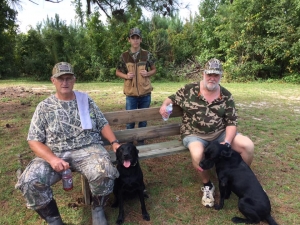 Gary Payne, Elijah Tang, and Kinard Fennell with their dogs, Hope and Ruger.