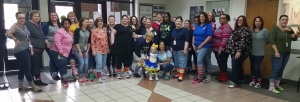 Richmond County Human Services employees pose with 2-year-old Charlotte Marks, all rocking their socks for World Down Syndrome Day. See the RO&#039;s Facebook page for video.