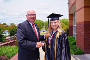  Dr. Dale McInnis, president of Richmond Community College, congratulates Academic Excellence Award winner Kristen Stuteville before the graduation ceremony on May 11.