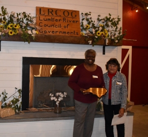 Hoffman Town Clerk Maggie Bethea is presented an award by Lumber River Council of Governments board member Linda Croom.