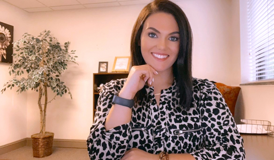 Richmond Community College graduate Brooke Deegan sits at her desk at Dawkins and Associates Insurance Agency. She graduated from the accounting program in 2017.