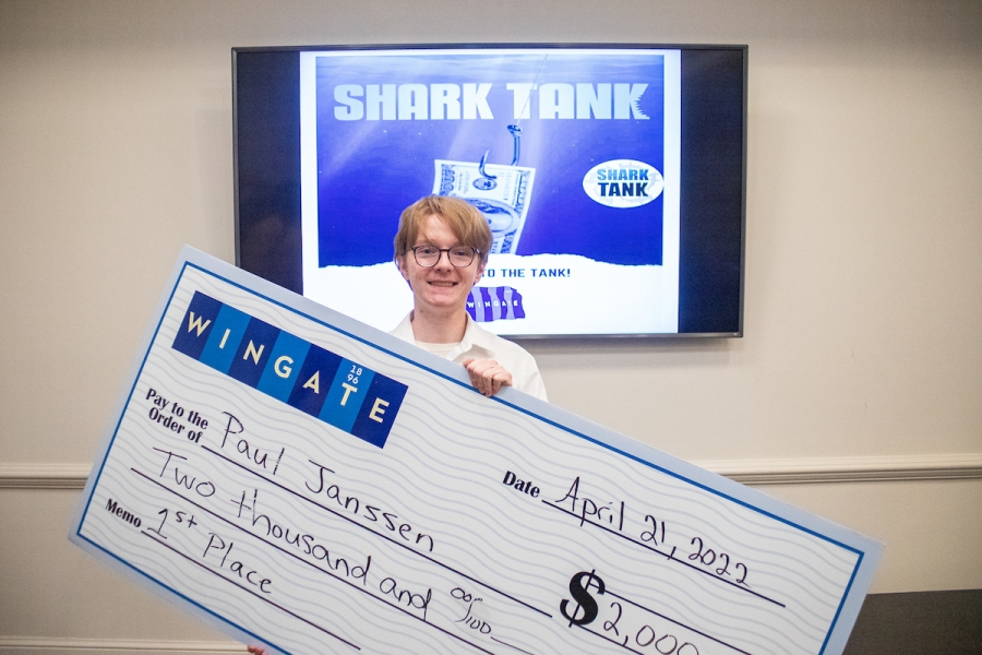 Senior Paul Janssen celebrates winning first place in Wingate University's Shark Tank competition.