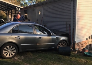 A gray sedan drove into a house in west Rockingham Sunday.
