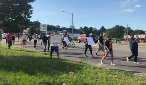 A group of protesters march down East Broad Avenue Sunday afternoon, calling for an end to racism and police brutality.