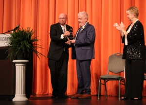 Richmond Community College President Dr. Dale McInnis presents the college Foundation&#039;s Distinguished Citizen of the Year award to retired health director Dr. Tommy Jarrell as Abbie Covington applauds.