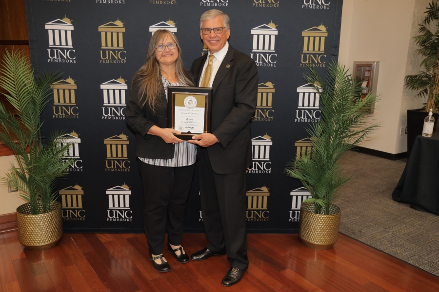 Donna Strickland is honored by Chancellor Robin Gary Cummings for her years of service to the college. 